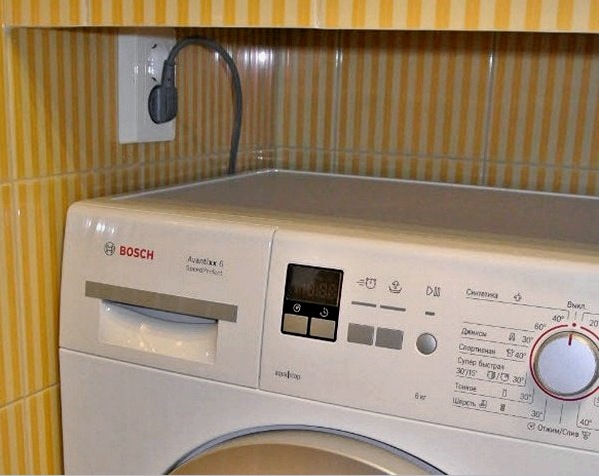 Un enchufe bajo la lavadora