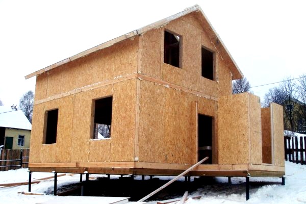 Construcción independiente de una casa de marco sobre una base de pilotes